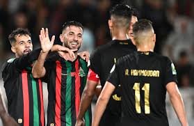 Soccer players celebrate a goal on the pitch, with one player wearing number 11 facing away while others cheer and high-five him.