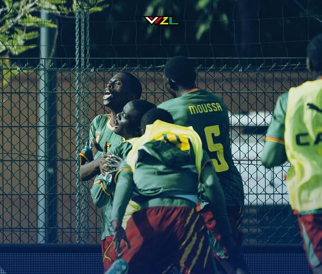 Soccer players in green jerseys celebrate near a chain-link fence, MOUSSA visible on one player's back, 5 on jersey number Soccer players in green jerseys celebrate near a chain-link fence, MOUSSA visible on one player's back, 5 on jersey number