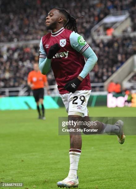 West Ham United player wearing a maroon claret jersey with number 29 runs on the pitch during a match, stadium spectators in the background. West Ham United player wearing a maroon claret jersey with number 29 runs on the pitch during a match, stadium spectators in the background.