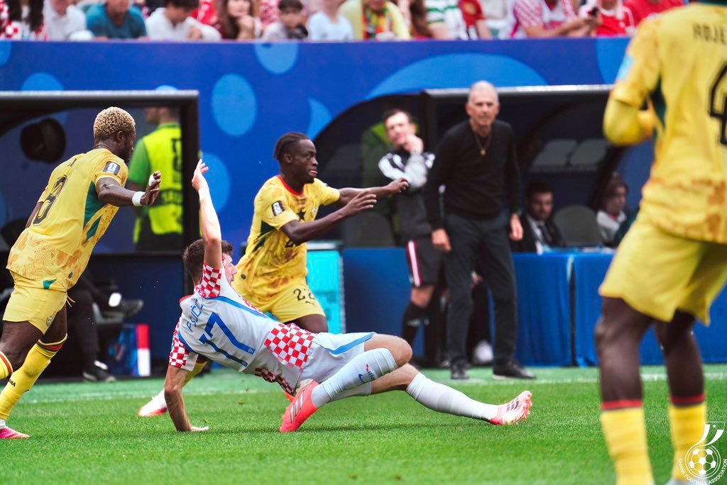 Soccer player in blue and white sliding on the field as yellow-clad players defend nearby. Soccer player in blue and white sliding on the field as yellow-clad players defend nearby.