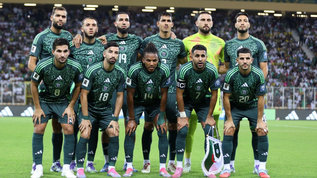 Algeria national football team posing for a pre-match group photo on the field in green uniforms. Algeria national football team posing for a pre-match group photo on the field in green uniforms.