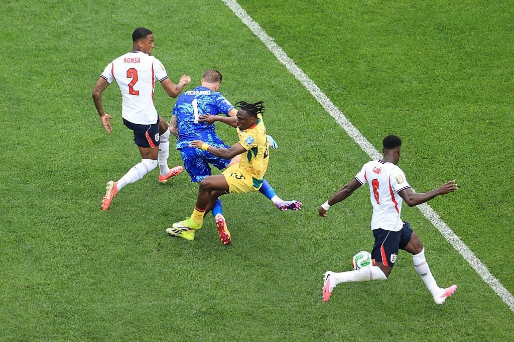 Soccer players contesting the ball near a white sideline on a green field; two in white jerseys, one in blue, one in yellow pursuing the ball. Soccer players contesting the ball near a white sideline on a green field; two in white jerseys, one in blue, one in yellow pursuing the ball.