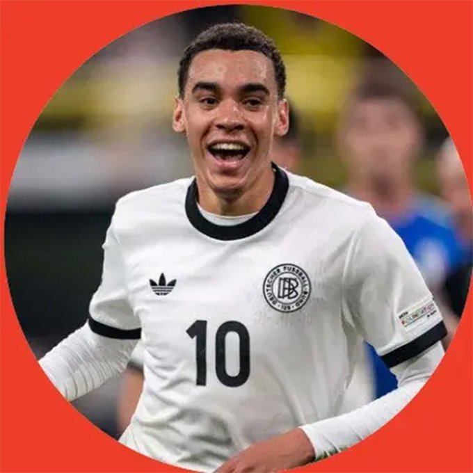 Male soccer player in a white jersey with the number 10, smiling and celebrating on the field; team crest visible on the chest.