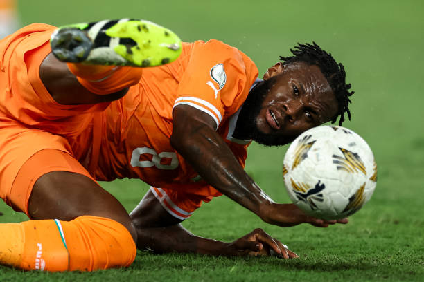 Soccer goalkeeper in orange reaching for the ball while on the green field, mid-dive to make a save Soccer goalkeeper in orange reaching for the ball while on the green field, mid-dive to make a save Soccer goalkeeper in orange reaching for the ball while on the green field, mid-dive to make a save Soccer goalkeeper in orange reaching for the ball while on the green field, mid-dive to make a save