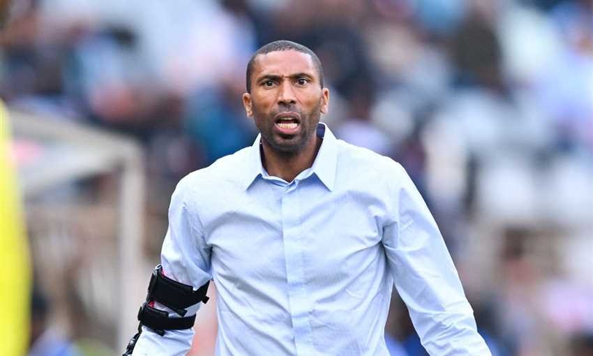 Soccer player in a light blue shirt on the field, wearing an arm brace, looking angry or determined. Soccer player in a light blue shirt on the field, wearing an arm brace, looking angry or determined.