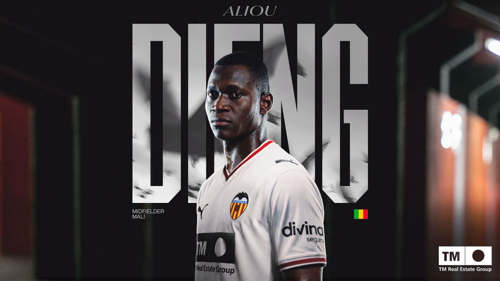 Portrait of a Mali midfielder in a Valencia CF white jersey, standing in a dim hallway with bold text behind him.