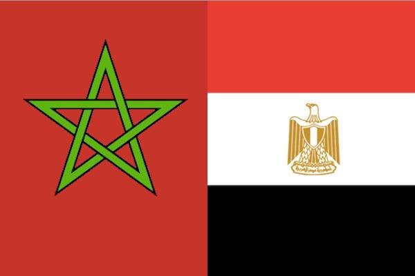 Flag of Morocco (red with green pentagram) and flag of Egypt (red, white, black horizontal stripes with gold eagle) displayed side by side. Flag of Morocco (red with green pentagram) and flag of Egypt (red, white, black horizontal stripes with gold eagle) displayed side by side.
