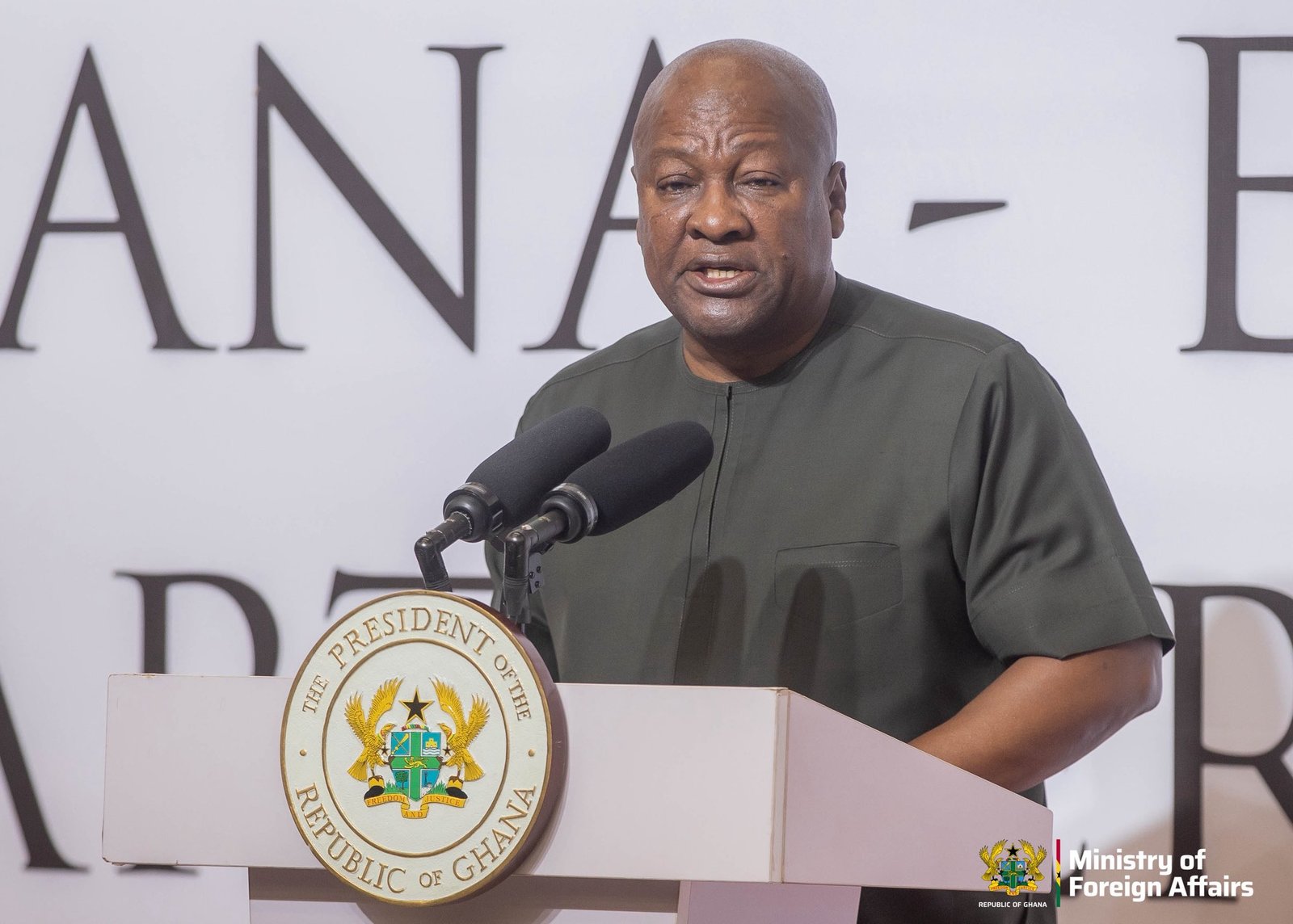 Gov. official speaking at a podium with the seal of the Republic of Ghana, Ministry of Foreign Affairs logo visible on the right. Gov. official speaking at a podium with the seal of the Republic of Ghana, Ministry of Foreign Affairs logo visible on the right.