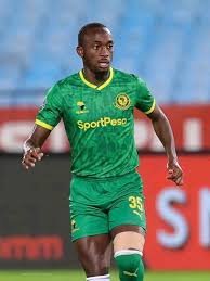 Soccer player in a green kit with number 35, running on a grass field during a match.