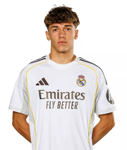 Young man wearing a Real Madrid white football jersey with Emirates Fly Better sponsor.