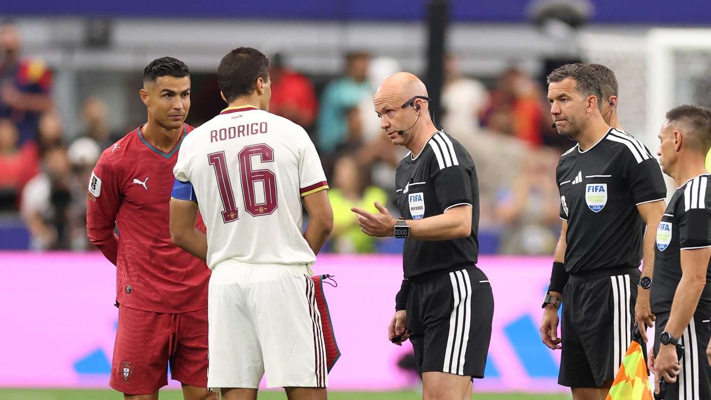 Soccer players and referees in black uniforms talk on the pitch; a white jersey with 'RODRIGO 16' is shown from the back.