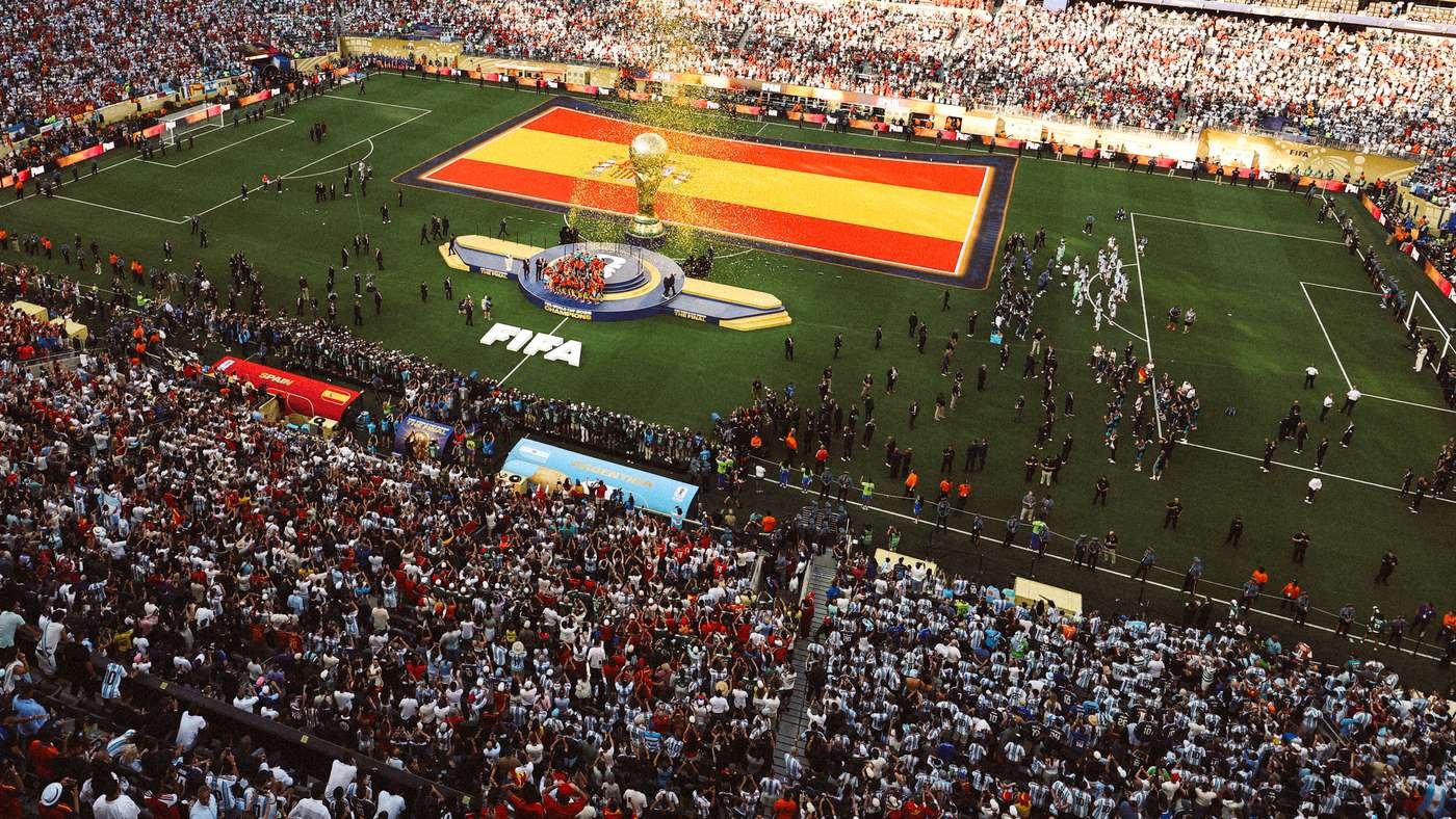 Aerial view of a packed stadium during a FIFA World Cup trophy ceremony on a football pitch by the center field.