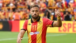 Soccer player in a red-and-yellow striped jersey giving a thumbs up on the field. Soccer player in a red-and-yellow striped jersey giving a thumbs up on the field.