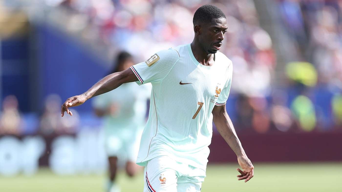 Soccer player in a light-blue France kit with number 7, running on the field during a match.