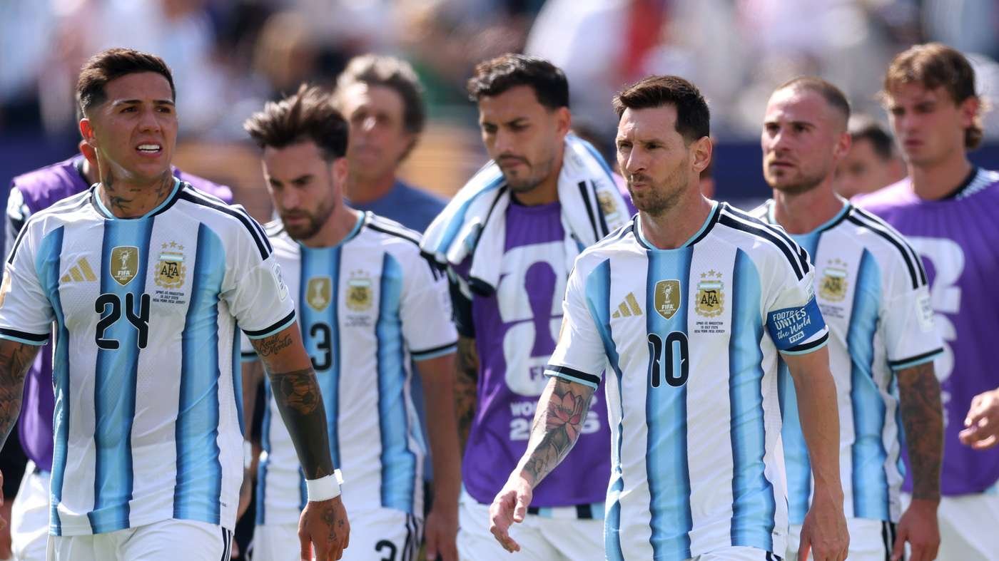 Argentina soccer players in light-blue and white striped kits walk together before a match.
