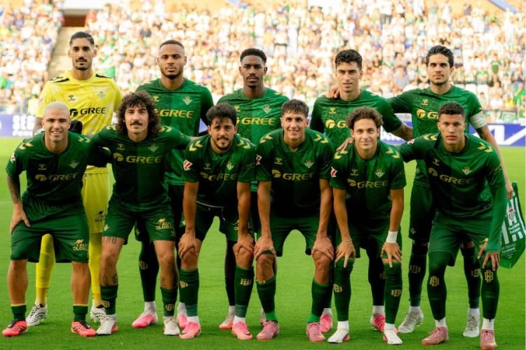 Soccer team in green jerseys posing for a pre-match photo on the field Soccer team in green jerseys posing for a pre-match photo on the field