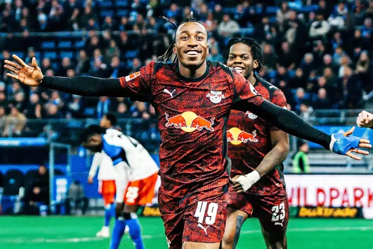 Two Red Bull soccer players celebrate on the field with arms outstretched as fans cheer in the stadium. Two Red Bull soccer players celebrate on the field with arms outstretched as fans cheer in the stadium.