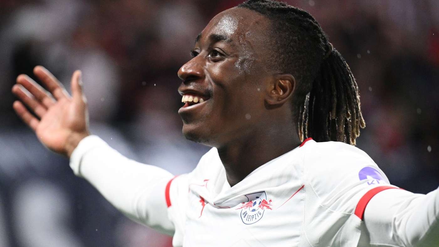RB Leipzig footballer celebrating with arms outstretched on the pitch, smiling after a moment of triumph RB Leipzig footballer celebrating with arms outstretched on the pitch, smiling after a moment of triumph