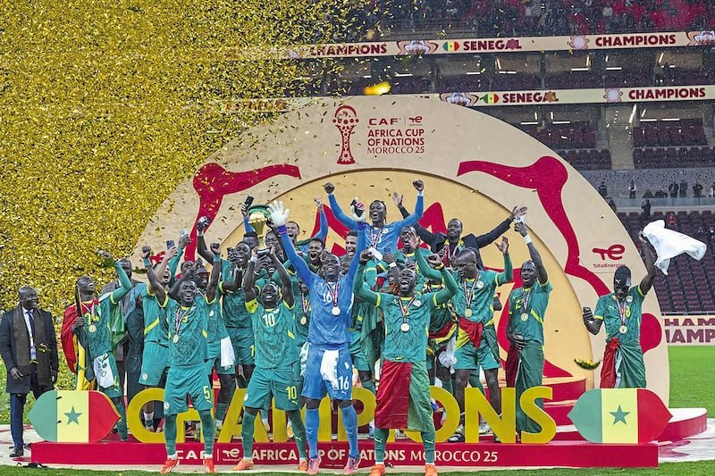 Senegal national football team celebrating their AFCON Morocco 2015 victory on stage with medals and trophy. Senegal national football team celebrating their AFCON Morocco 2015 victory on stage with medals and trophy.