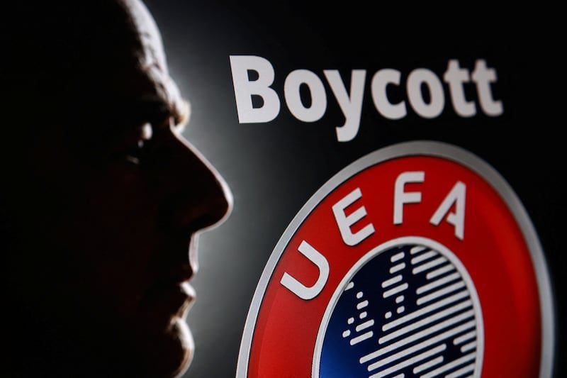 Silhouette of a person beside a UEFA emblem with the word 'Boycott'—image advocating boycott activity.