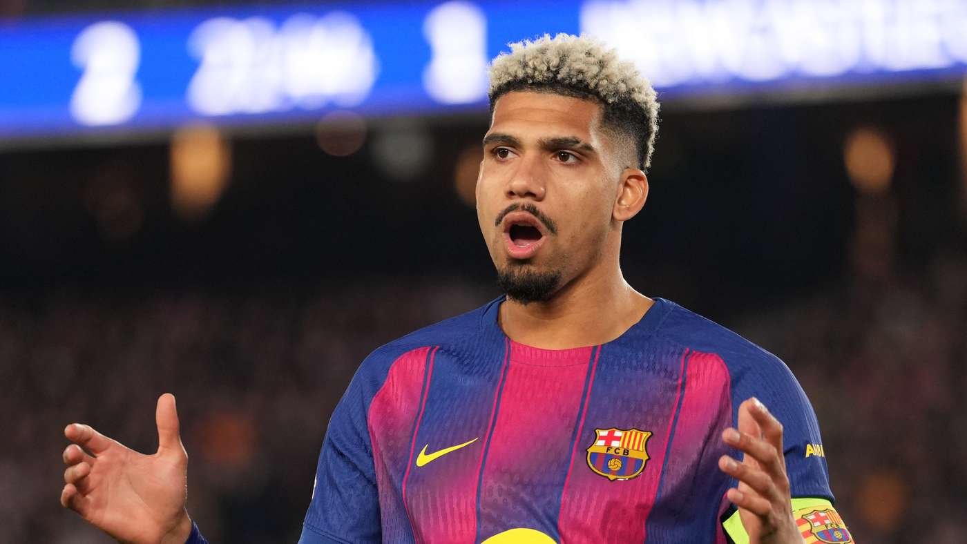Footballer in FC Barcelona jersey with crest and yellow Nike swoosh, arms outstretched and mouth open during a match.