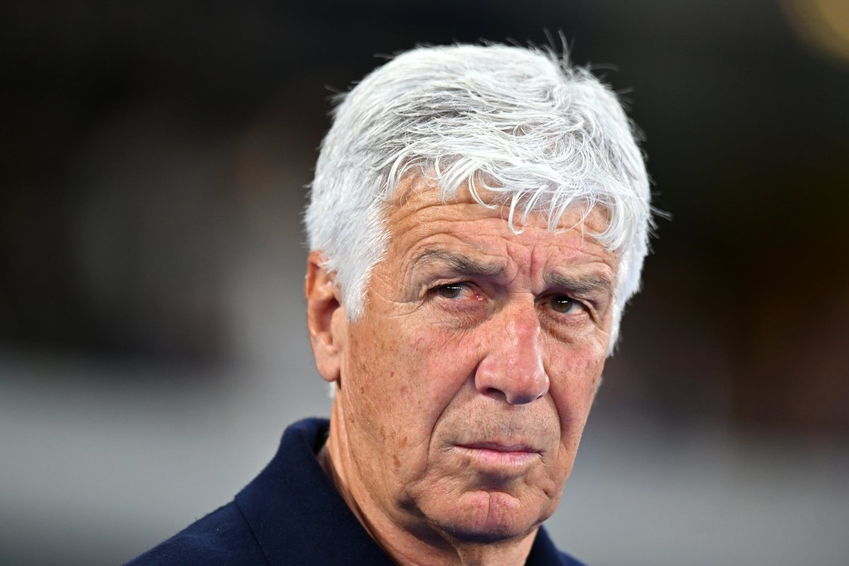 Close-up portrait of an older man with white hair and a serious, contemplative expression outdoors.