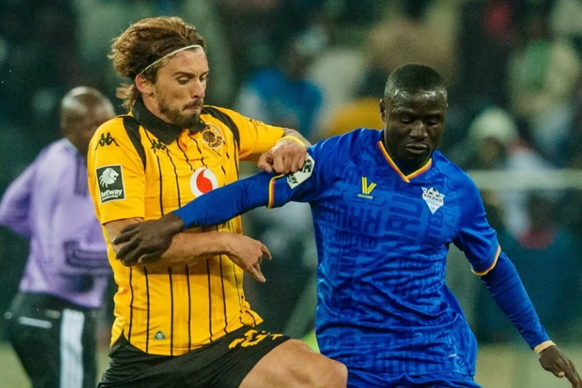 Two soccer players struggle for the ball during a match, one in a yellow striped jersey, the other in blue, in close contact. Two soccer players struggle for the ball during a match, one in a yellow striped jersey, the other in blue, in close contact.