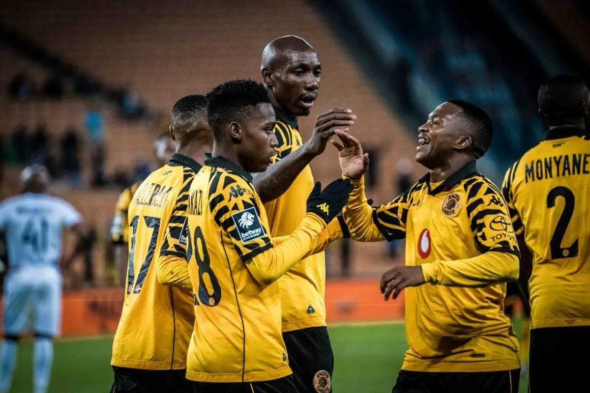 Soccer players in yellow and black uniforms celebrate on the field, giving high-fives and smiles.
