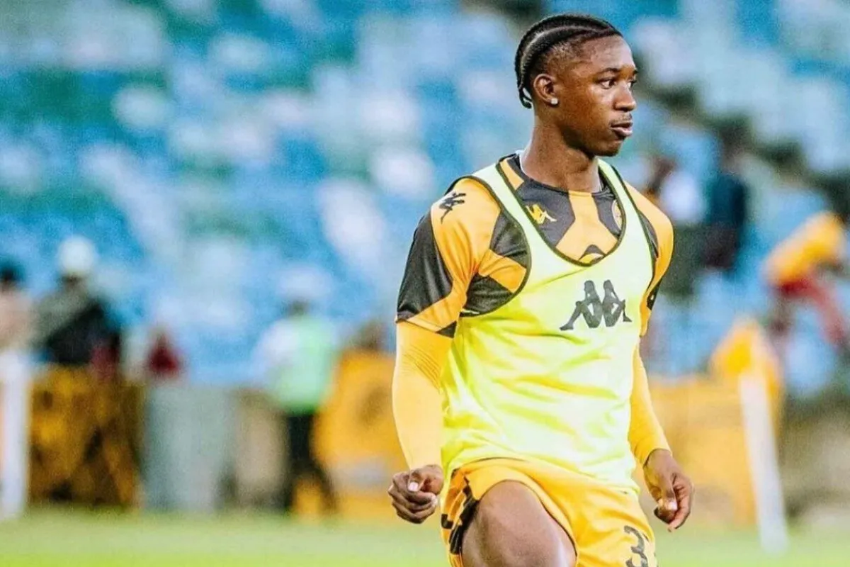 Soccer player in a bright yellow training bib on a grassy field, focused and walking. Soccer player in a bright yellow training bib on a grassy field, focused and walking.